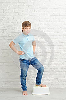 Portrait of a boy of European appearance on a light background, blond boy 9 years old