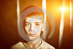 Portrait of a boy with flare, toned photo