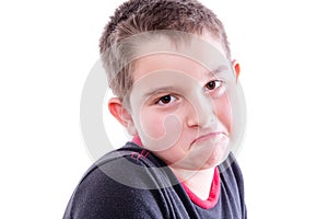 Portrait of Boy Frowning in White Studio