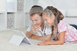 Portrait of boy and girl with tablet pc