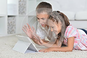 Portrait of boy and girl with tablet pc