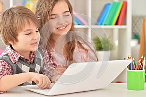 Portrait of Boy and girl using laptop
