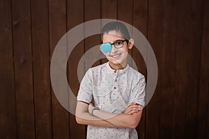 Portrait of boy in glasses with patch. Eye patch for glasses t treat lazy eye, amblyopia, strabismus.