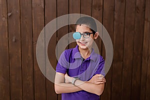 Portrait of boy in glasses with patch. Eye patch for glasses t treat lazy eye, amblyopia, strabismus.