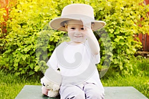 Portrait of a boy in a hat, outdoors in summer.