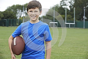 Portrait Of Boy Holding Ball On School Football Pitch