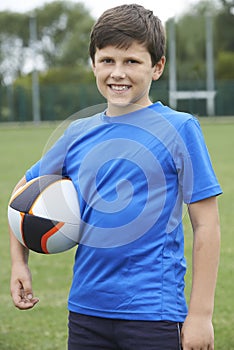 Portrait Of Boy Holding Ball On School Rugby Pitch