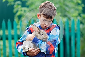 Portrait of boy, he is holding rabbit