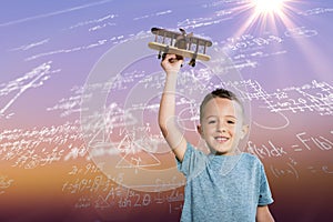 Composite image of portrait of boy holding toy airplane