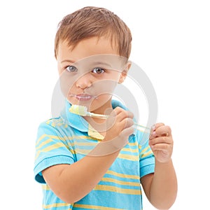 Portrait, boy and kid brushing teeth in studio for hygiene, learning healthy oral habits and care on white background