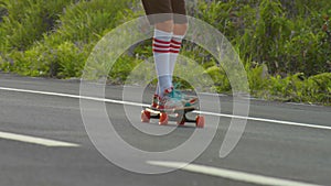 Portrait boy with a longboard on a beautiful road. Teenager skateboarding on city streets