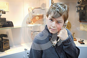 Portrait of a boy with old handset in the photo