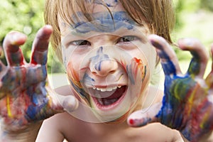 Portrait Of Boy With Painted Face and Hands