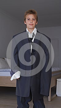 Portrait, boy and pretend suit on male person, oversized business clothes for dream job on child. Dress up, kid and