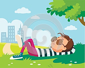 Portrait of a boy resting on green lawn