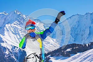 Portrait of boy in Santa Claus hat hold snowboard lift hand