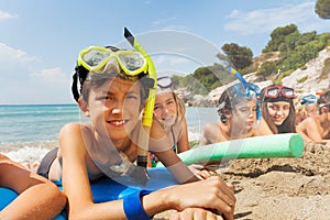 Boys and girls in scuba masks on the beach