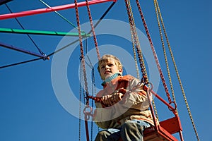 Portrait of boy seated in carousel