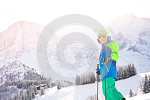 Portrait of a boy in ski clothes over mountain