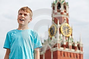 Portrait of boy in t-shirt against Spassky tower