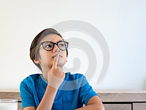 Portrait of a boy thinking looking up on white background