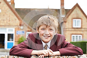 Portrait Of Boy In Uniform Outside School Building