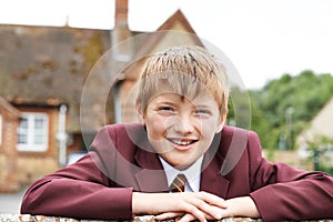 Portrait Of Boy In Uniform Outside School Building