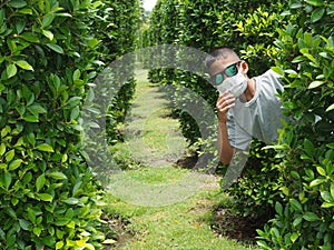 Portrait of a boy wearing black glasses And wearing a protective mask On a green background