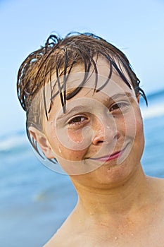 Portrait of a boy with wet hair at the beach