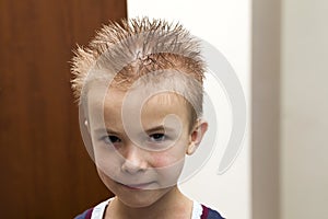 Portrait of a boy with wet hair after taking a shower of bath. F