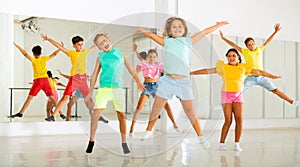 Portrait of boys and girls jumping having fun after dance class