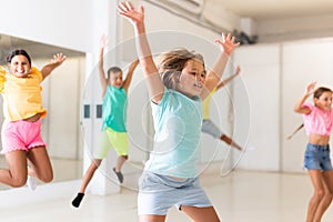 Portrait of boys and girls jumping having fun after dance class