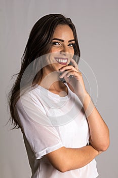Portrait of Brazilian young female brunette model with arms crossed and smiling with confidence