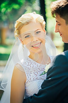 Portrait the bride and groom on the background of the park alley