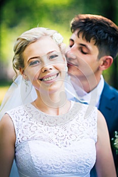 Portrait the bride and groom on the background of the park alley