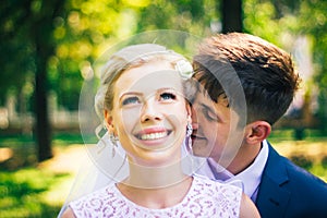 Portrait the bride and groom on the background of the park alley