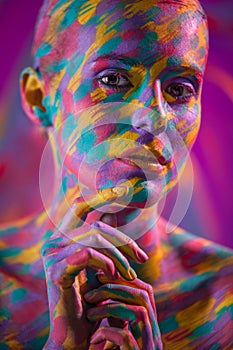 Portrait of the bright beautiful girl with brush, art colorful make-up face art and bodyart