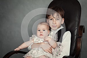 Portrait of brother and sister on gray background