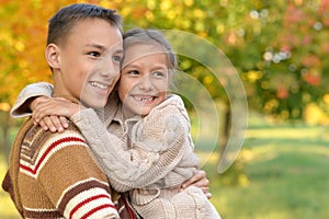 Portrait of brother and sister in park