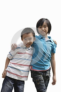Portrait of brother and sister standing against white background