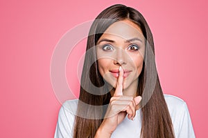 Portrait of brown-haired gorgeous attractive nice cute funny smililng young lady showing shhh taboo sign with finger to