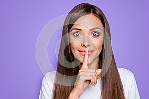 Portrait of brown-haired gorgeous attractive nice cute funny smililng young lady showing shhh taboo sign with finger to