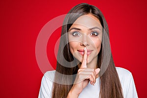 Portrait of brown-haired gorgeous attractive nice cute funny smililng young lady showing shhh taboo sign with finger to photo