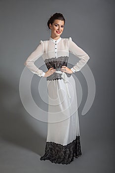 Portrait of brunette beautiful girl posing in retrostyle dress