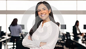 Portrait of a brunette business student in a modern technology office space, cheerful successful smile, teamwork concept