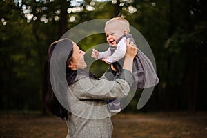 Portrait of brunette mother playing with a cute baby daughter