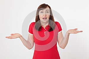 Portrait of brunette surprised happy woman in blank red t-shirt with copy space on white background. Mock up. Menopause