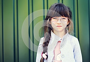 Portrait of brunette toddler girl in glasses