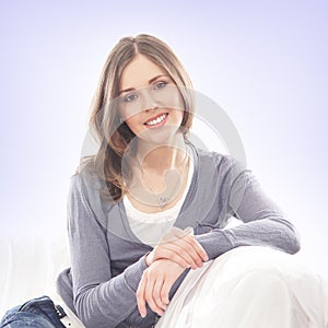 Portrait of a brunette woman in a blue sweater