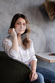 portrait of brunette woman girl in loft cafe. coffee break. lunch time. happy worker. business woman relax